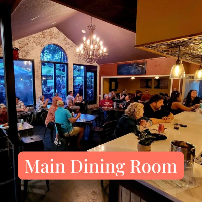 Patrons dining and socializing in the main dining room and bar area of Succotash Southern and Creole Kitchen.